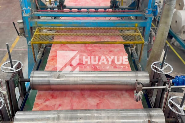 A vibrant display of fiberglass insulation rolls in various colors and thicknesses