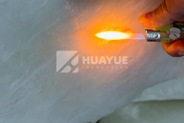 Fiberglass insulation being tested with a blowtorch