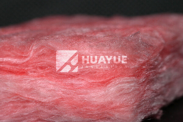 A close-up of pink fiberglass insulation batts