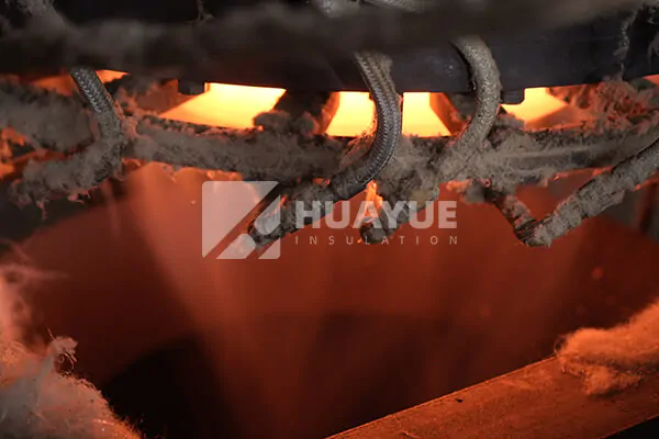 An industrial furnace glowing during the glass melting process