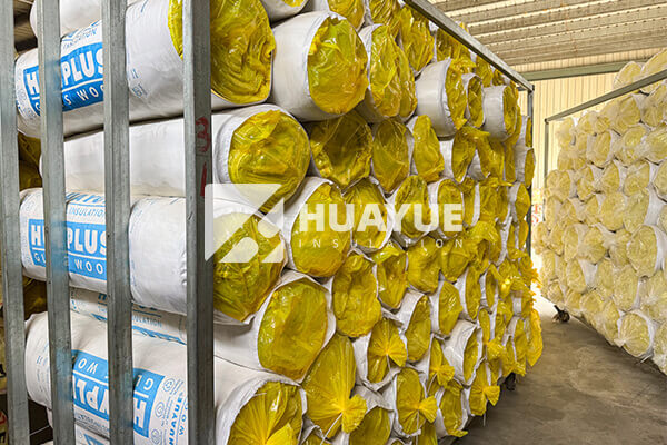 A large warehouse filled with pallets of HUAYUE branded insulation ready for shipping