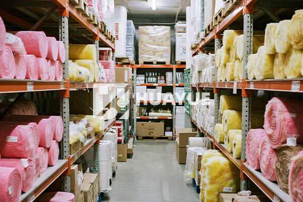 A shot of fibreglass insulation rolls neatly stacked in a home improvement store aisle