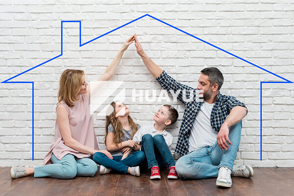 A happy family in a comfortable living room, implying a safe and well-insulated home