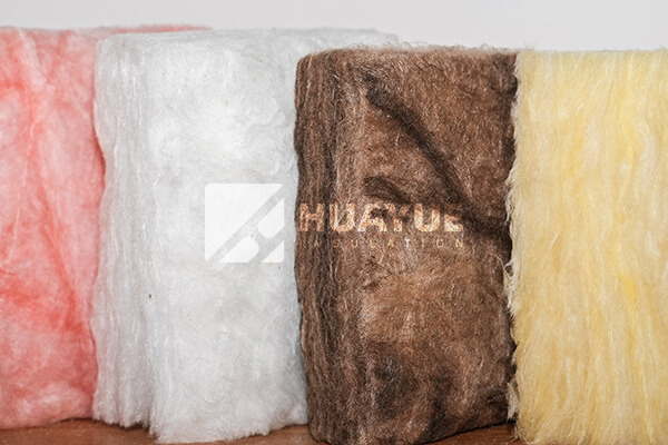 A close-up view of unfaced fiberglass insulation