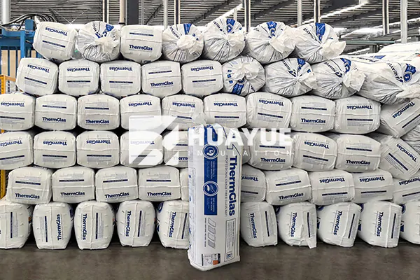 A large, modern warehouse filled with pallets of neatly stacked insulation ready for global shipping