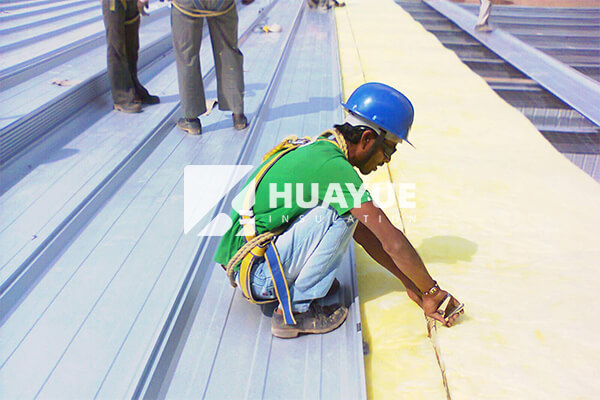 House fiberglass insulation application scene