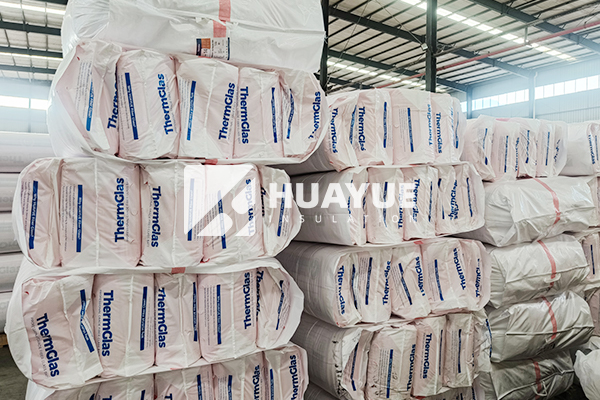 Pink Batts glass wool insulation sheets stacked in factory storage