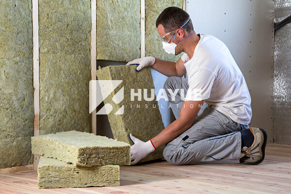 installing mineral wool in a wall cavity