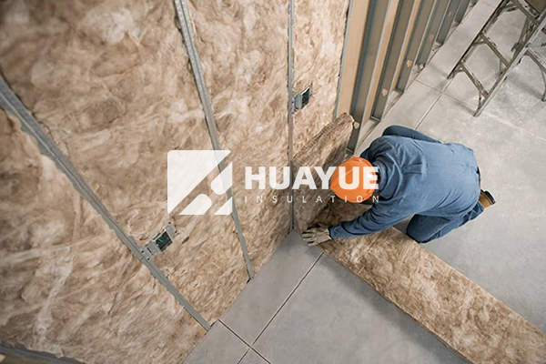 Fiberglass insulation rolls in steel building