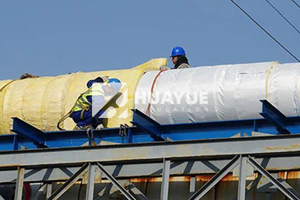 fiberglass insulation being installed in industrial setting