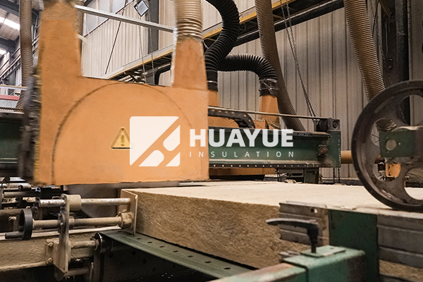Rock wool slab, 24 inch width, being cut to size on factory floor