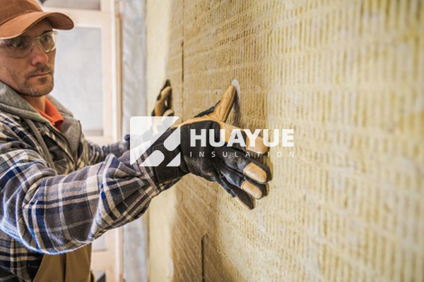 rock wool insulation installation detail showing protective equipment