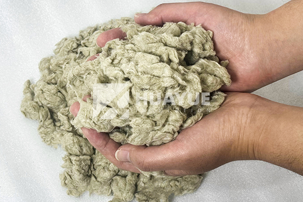 rock wool loose-fill product being delivered through a blowing hose