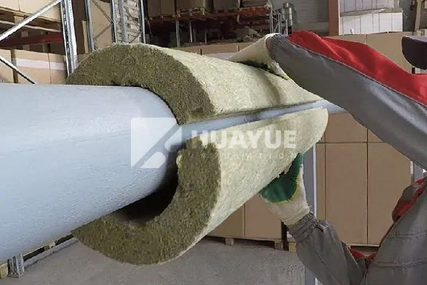 Semi-rigid mineral wool pipe section installed around insulated equipment