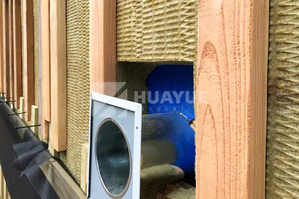 Rock wool board installation inside a framed wall cavity